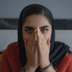 Indian girl covering her mouth expressing shock.